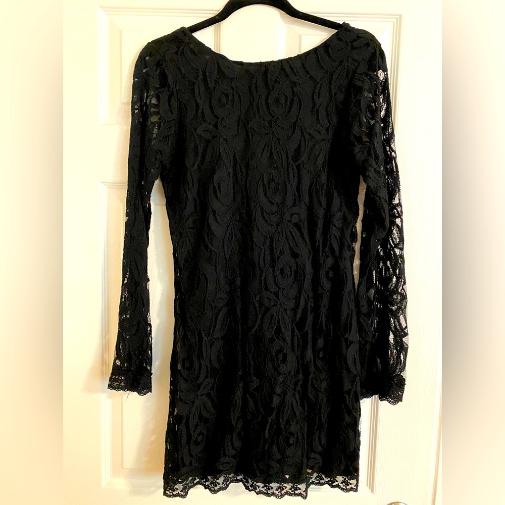 Black long sleeved, lace dress w/scoop back. Never worn. NWT